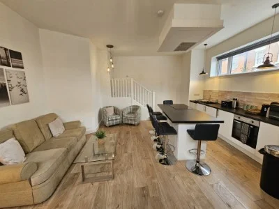 Lounge and fitted kitchen at Kings Central Apartment