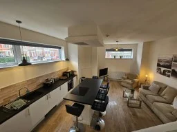 Open-plan kitchen and living room at Kings Central Apartment