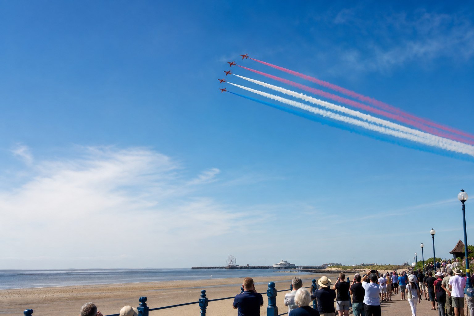 Aerobatic aircraft displaying above a British seaside promenade